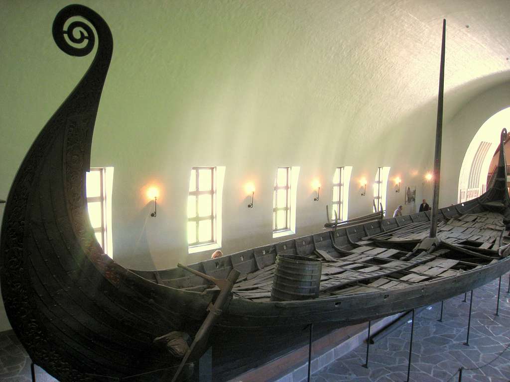 Viking ship suspensed atop metal supports in open museum room