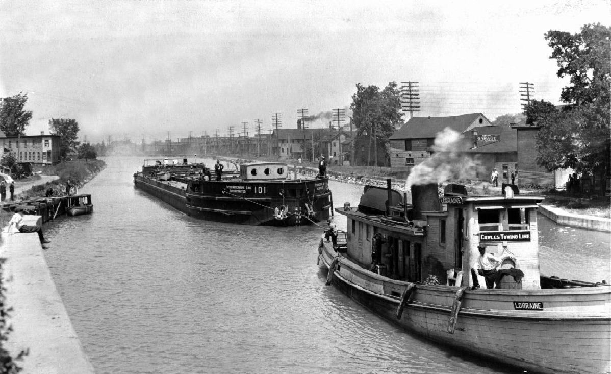 barge and  tugboat transiting canal