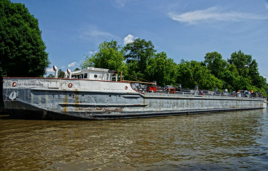 grey canal cargo ship on the water
