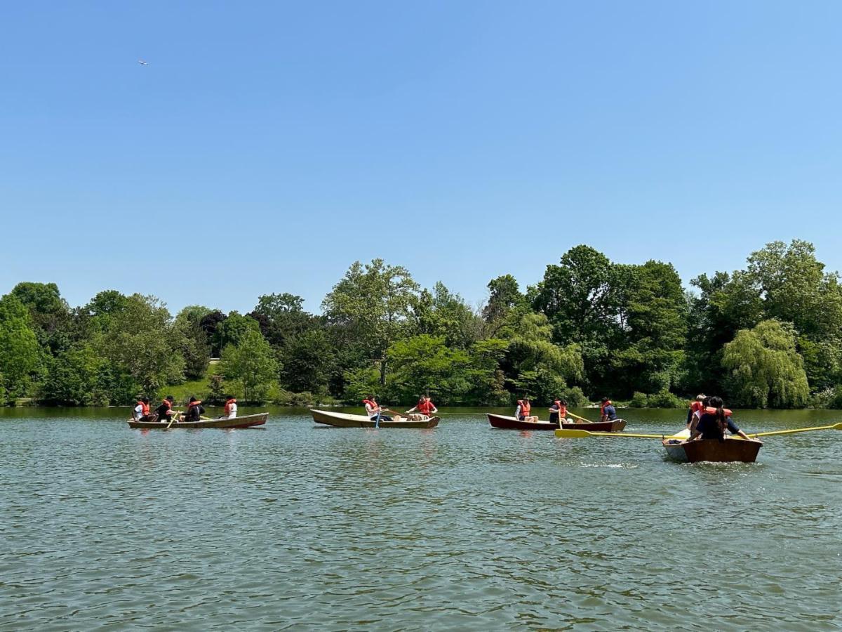 four boats carrying people with oars
