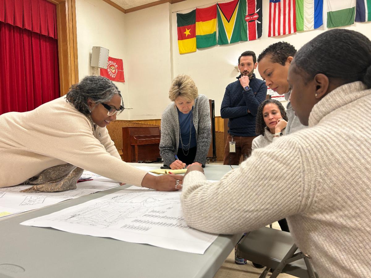 Architects and District administrators review floor plans at Mercer.