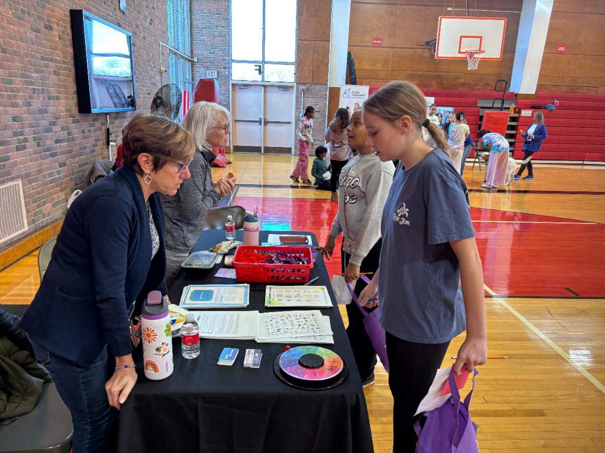 A Middle School student visits a table at the Sources of Strength Wellness Fair.