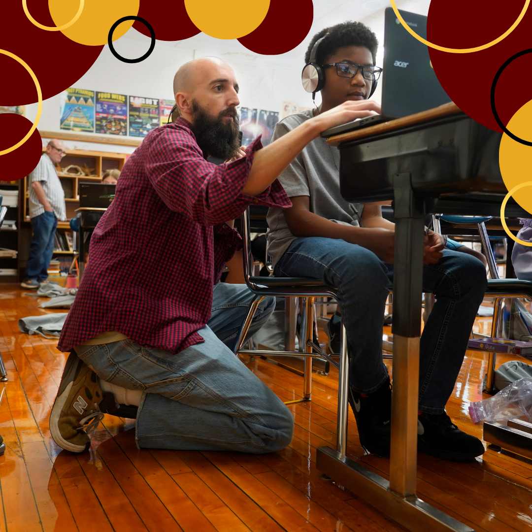 An intervention specialist helps a student with an assignment on his laptop.