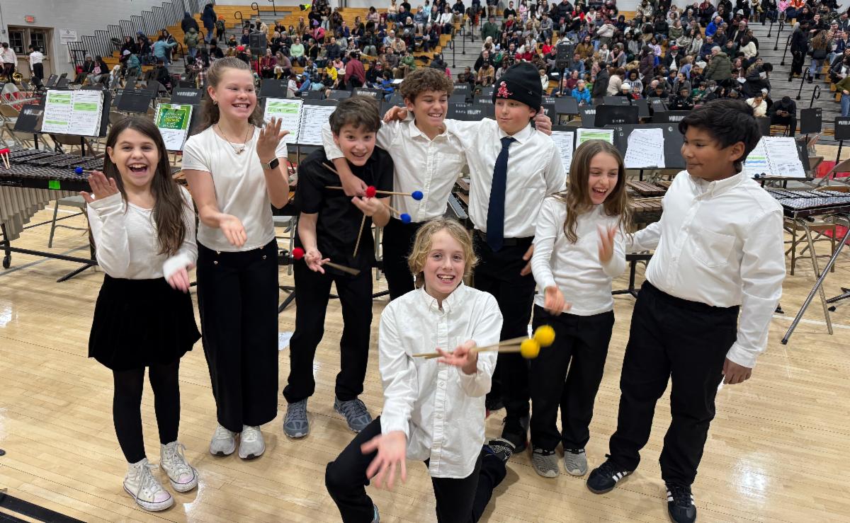 Students from the percussion section hold their mallets and do the 6-7 motion with their hands.