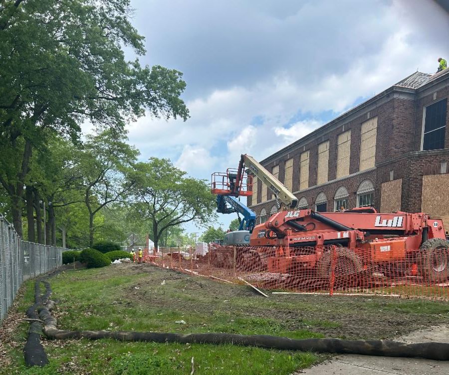 This picture shows a construction truck parked outside Ludlow, surrounded by orange fencing that protects tree root zones.