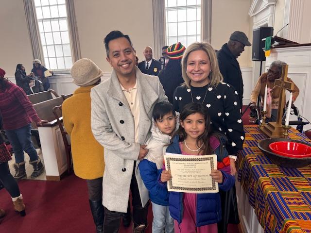The Ciriaco family poses for a photo after Charlotte accepts her certificate.