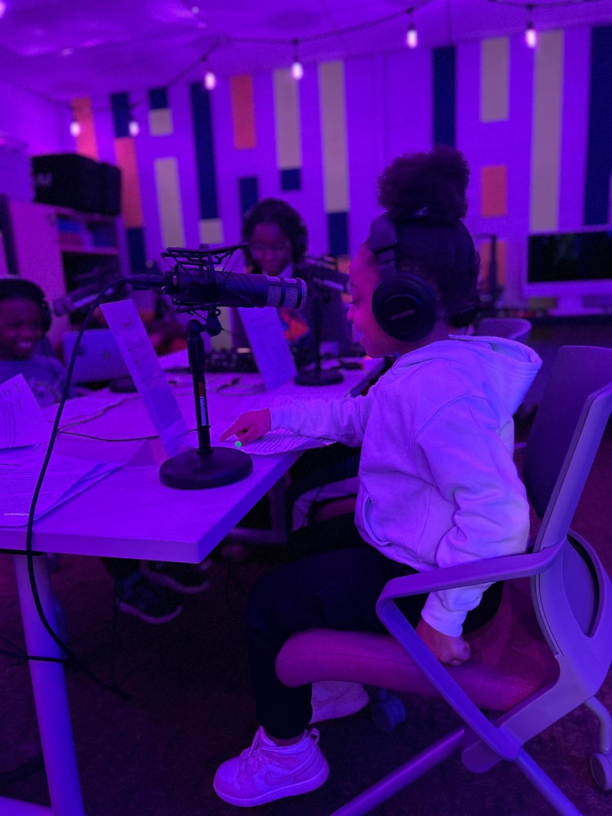 A Fernway student speaks into a microphone in the podcast studio at the Innovative Center for Personalized Learning.
