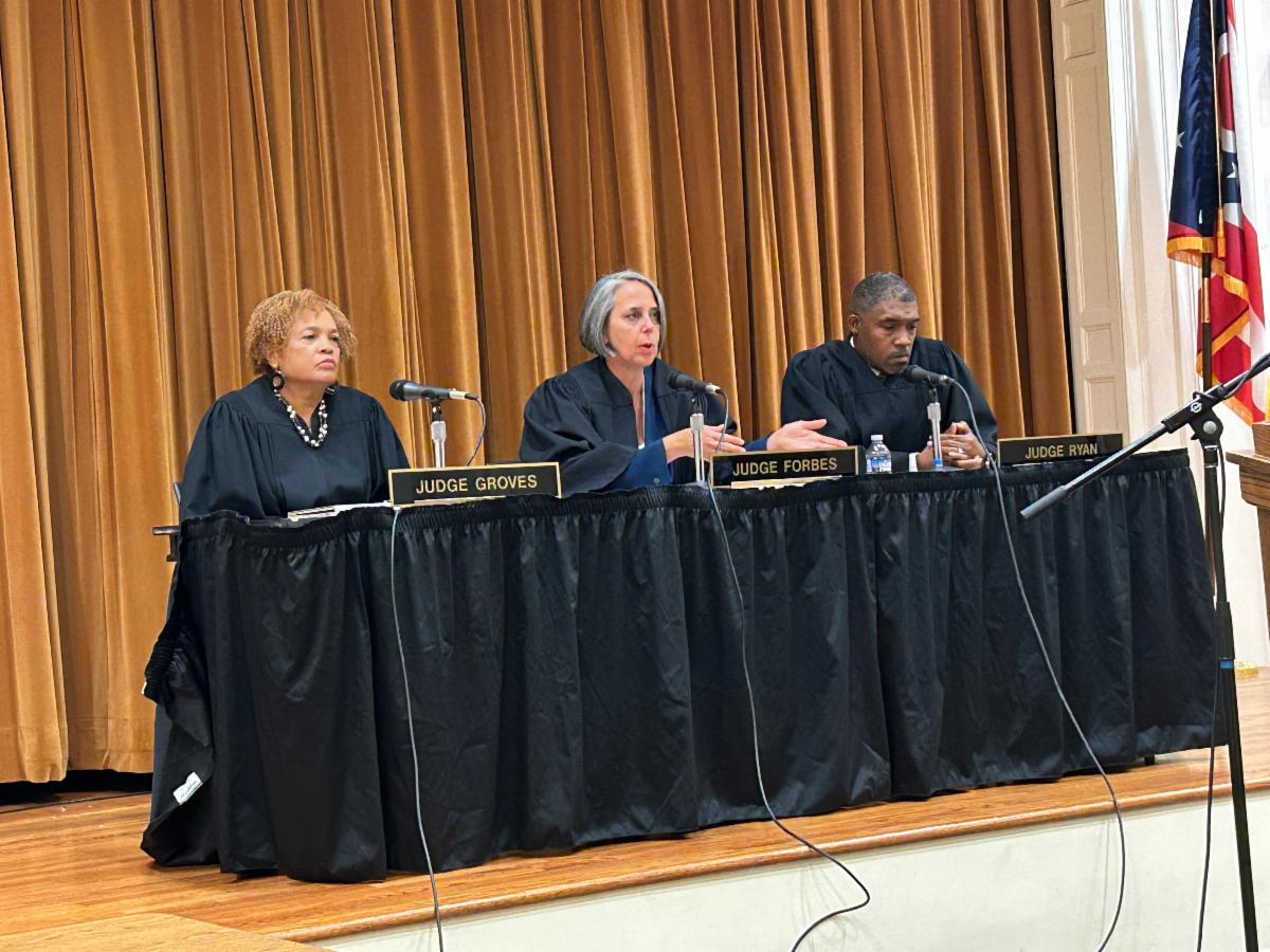 Three judges sit on the stage during Courtroom to Classrooms at SHHS.