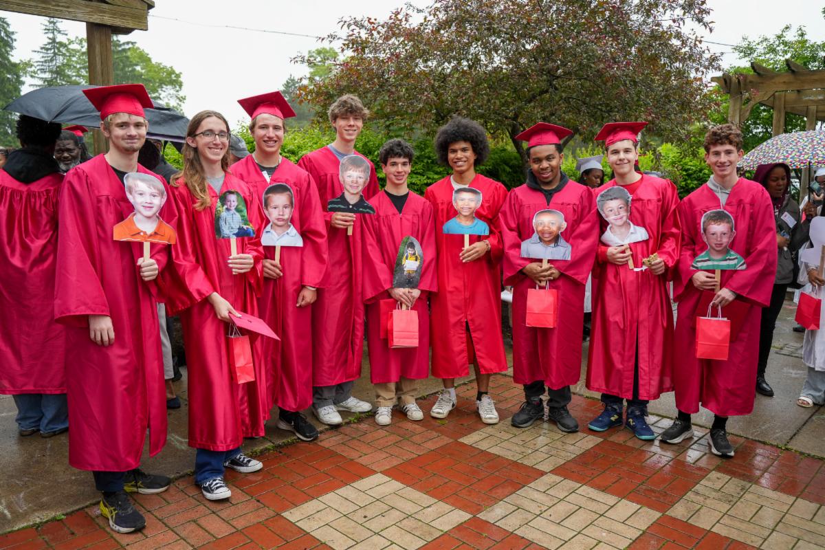 Seniors pose in their caps and gowns outside Lomond Elementary School during Senior Clap Out.