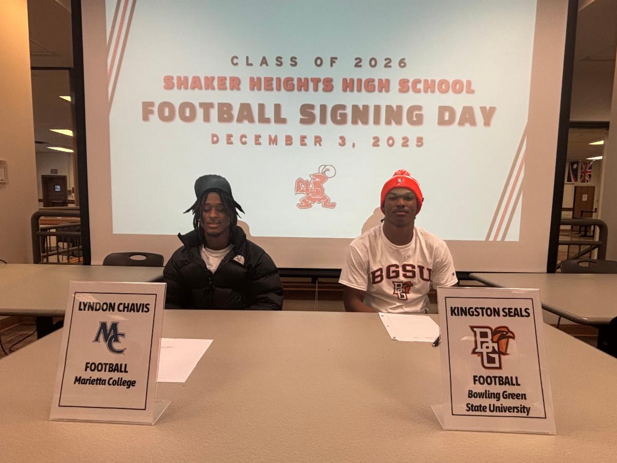 Lyndon Chavis and Kingston Seals pose for a picture while sitting at a table on Signing Day.