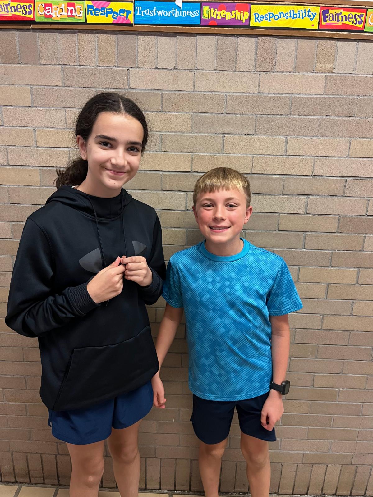 Two Lomond students pose for a photo in the hallway.