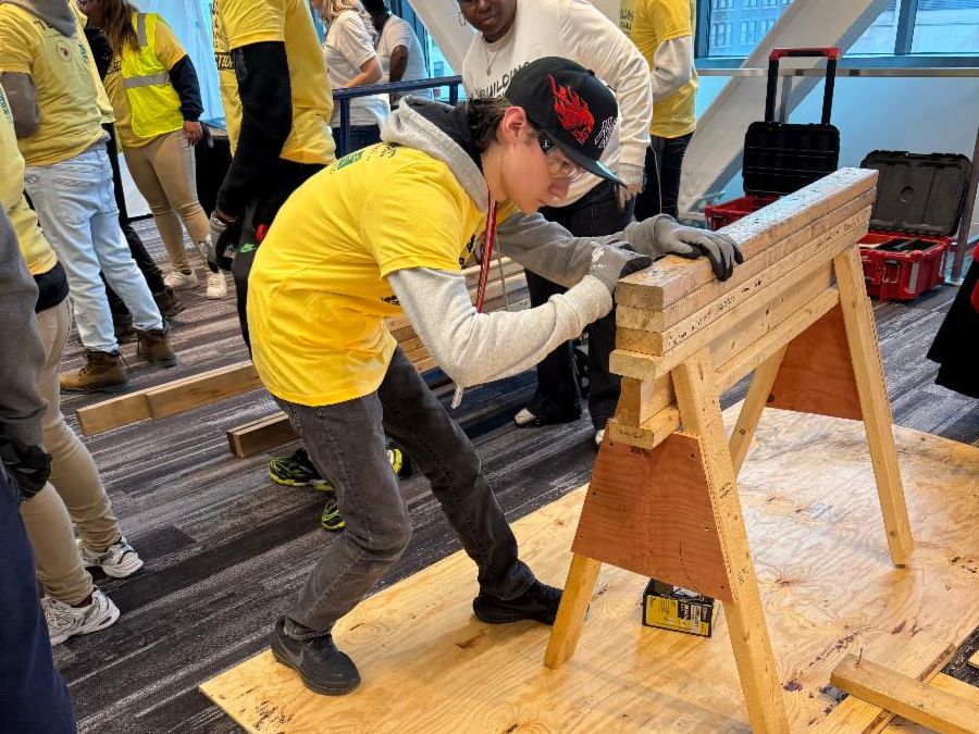 A SHHS student practices carpentry skills with wood at the I built this event.