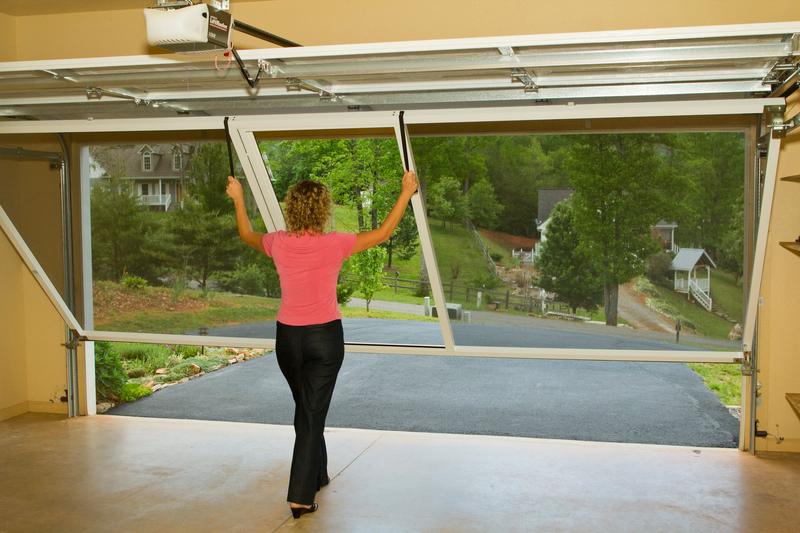 Lifestyle garage screen being raised by one person