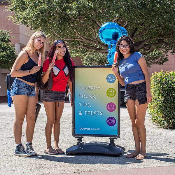 UCI students with popsicles posing in front of Science Library during 2026 Welcome Week