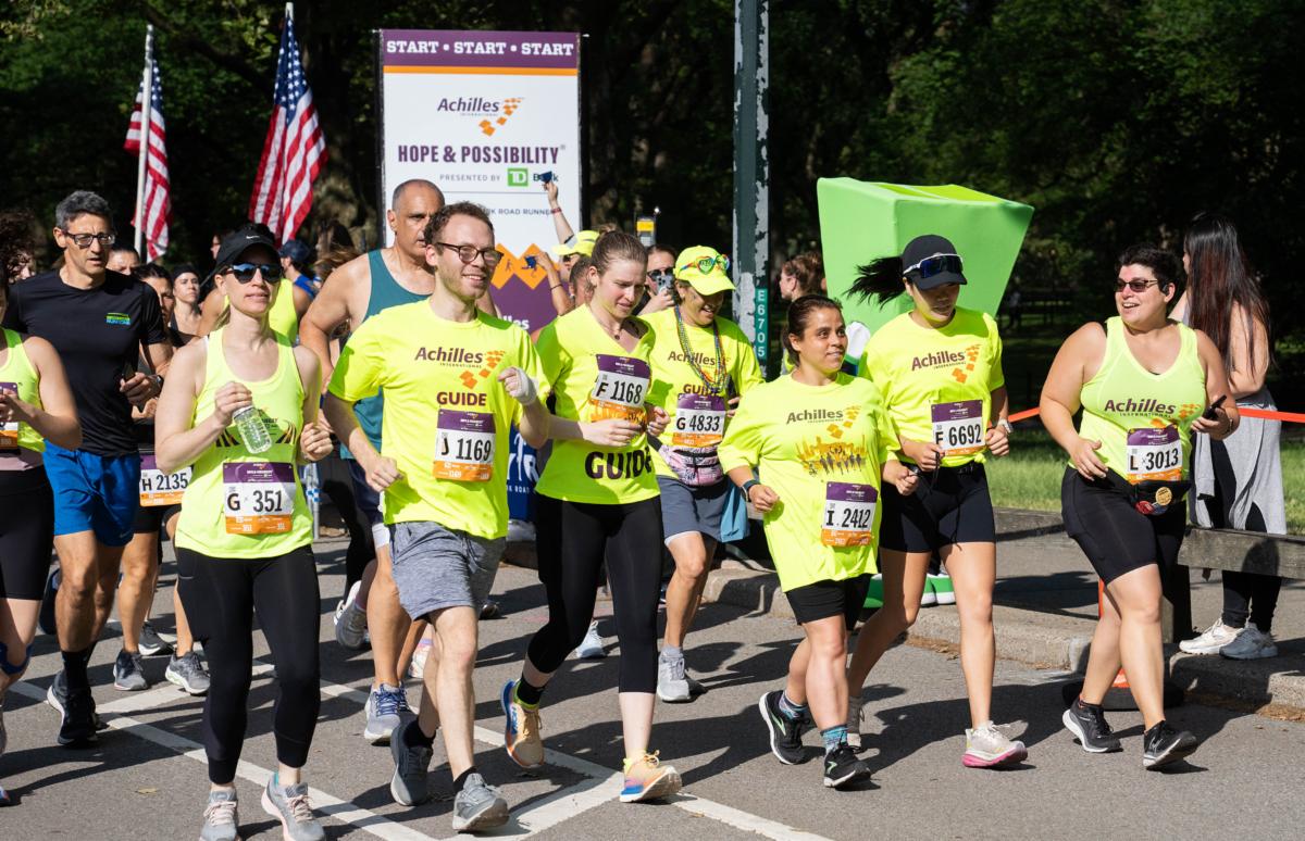 Achilles athletes running across start line
