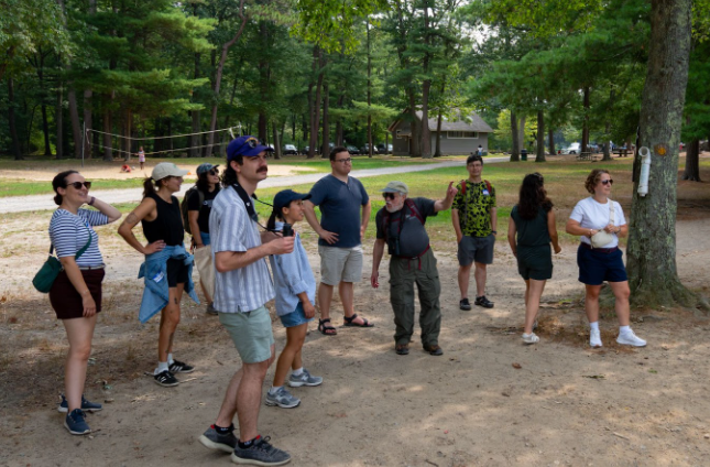A group of MPO staff members are standing together at Houghtons Pond.