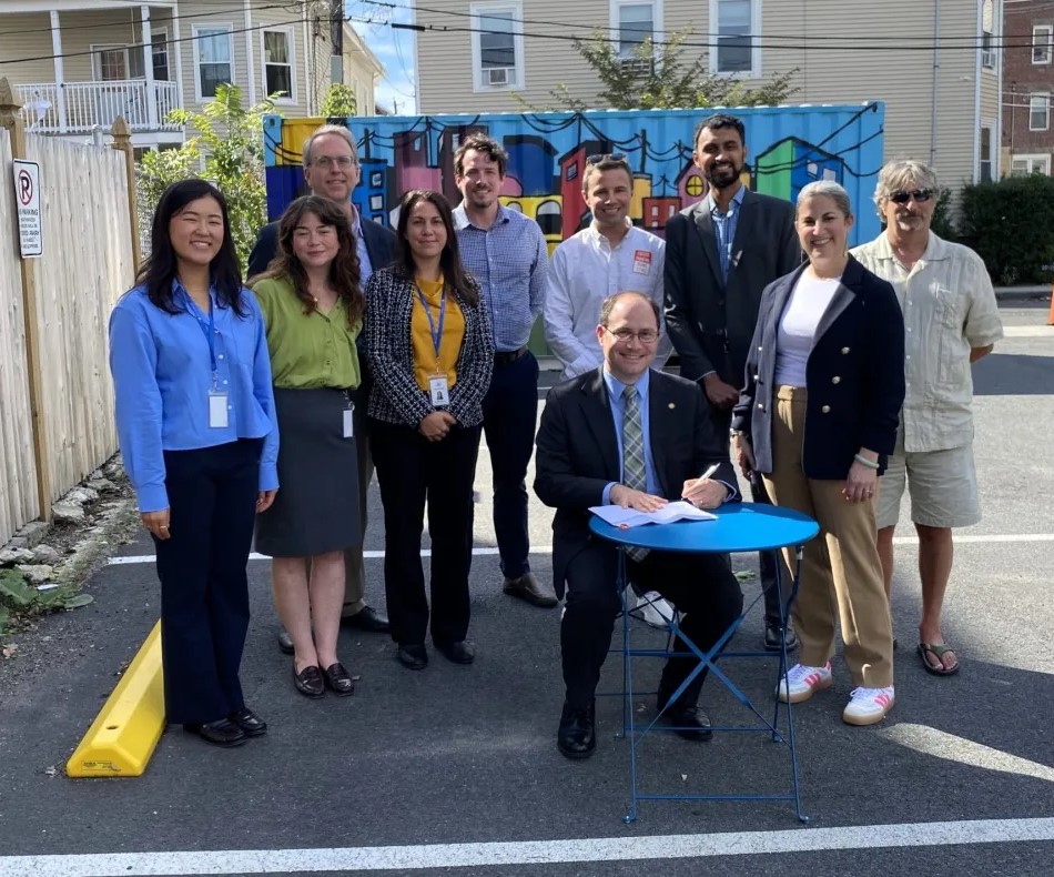 MAPC Executive Director Lizzi Weyant and Senior Transportation Planner Adi Nochur joined Salem Mayor Pangallo Salem City Councilors and staff and members of their Affordable Housing Trust Fund Board and Planning Board for the Salem parking reform signing.