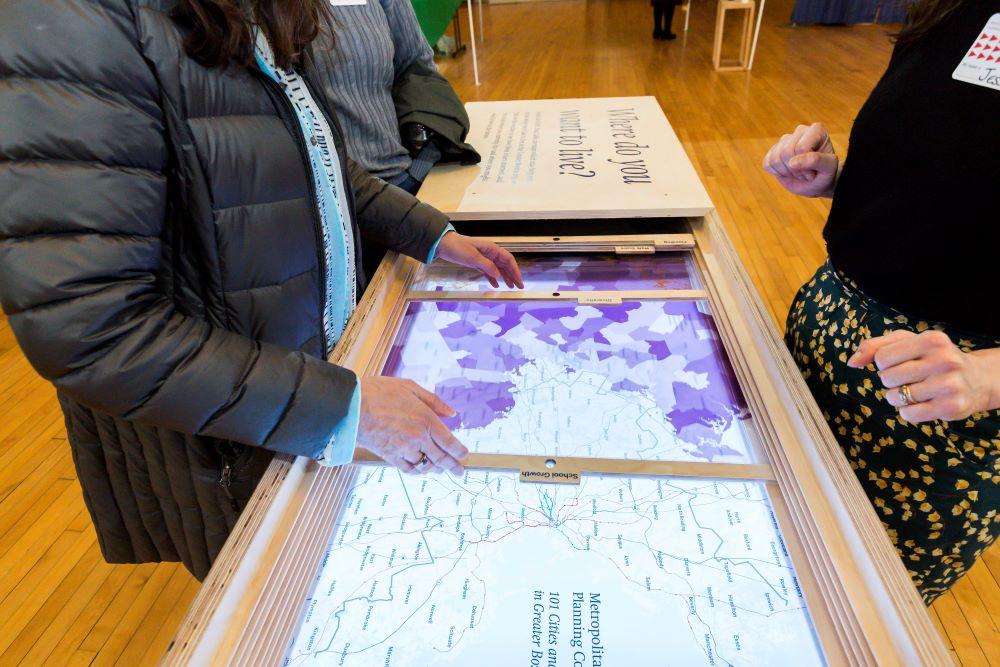 A blue map of the Metro Boston region, broken up into each town and city within the region. The names of each town and city is written in white on the map.