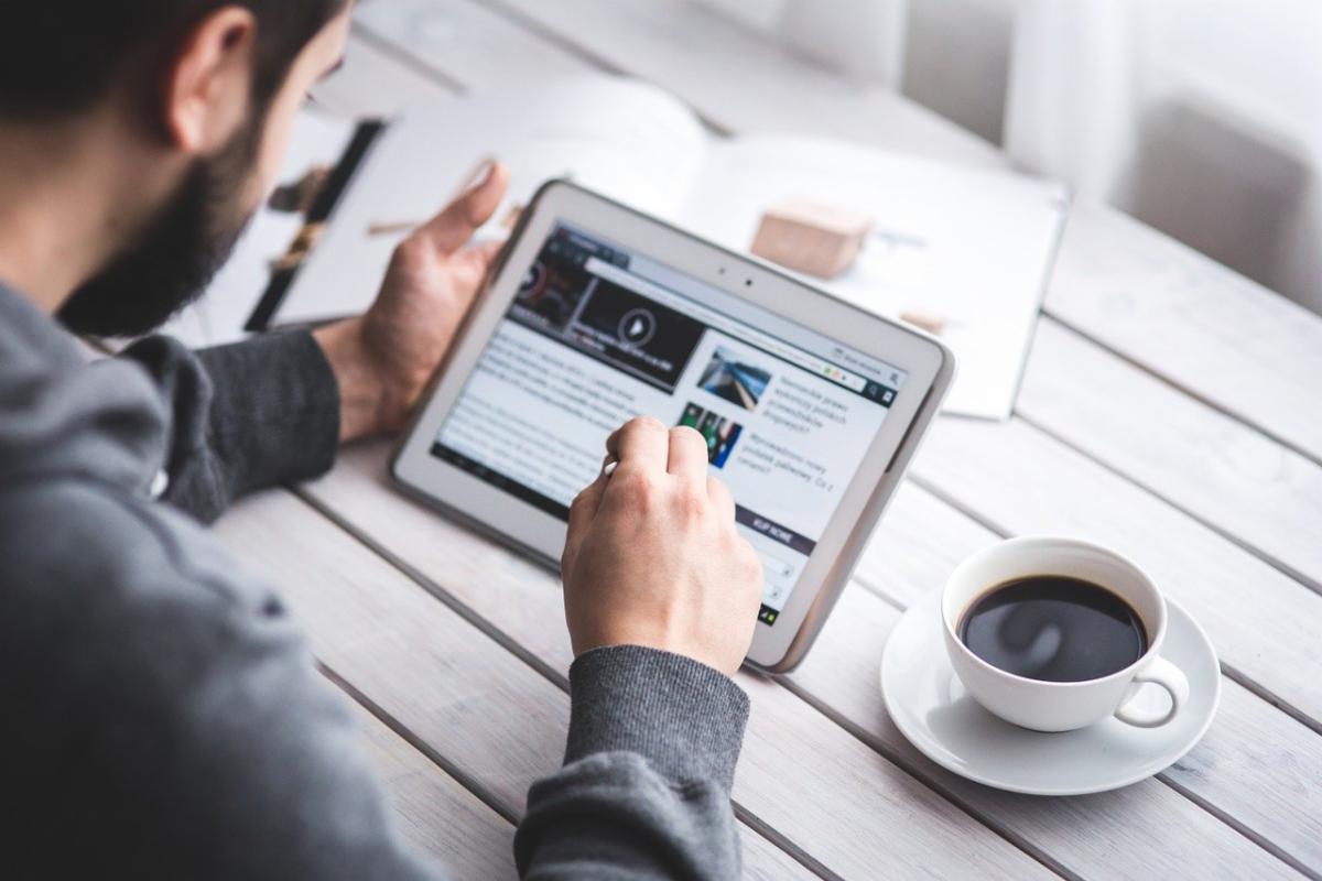 man reading on tablet