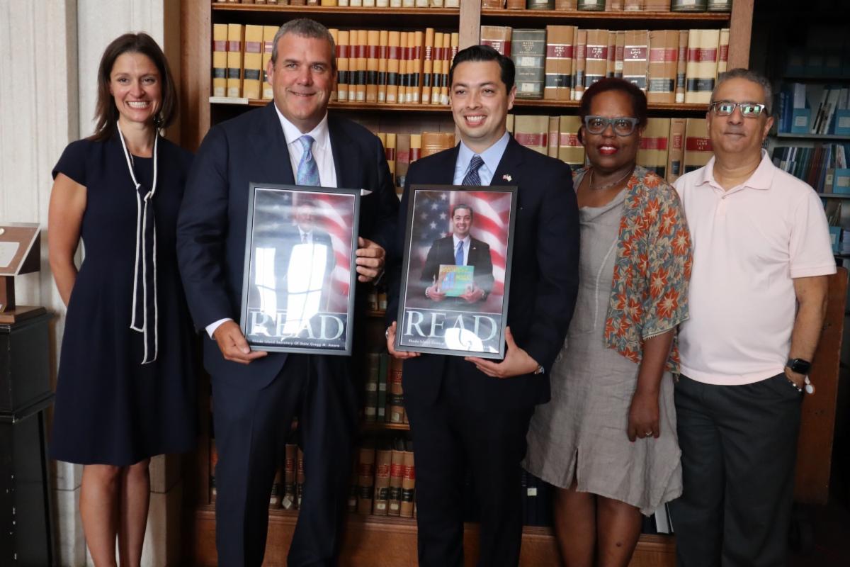 Beatrice Pulliam, Ed Garcia, Megan-Hamlin Black present Greg Amore and James Diossa with READ posters 