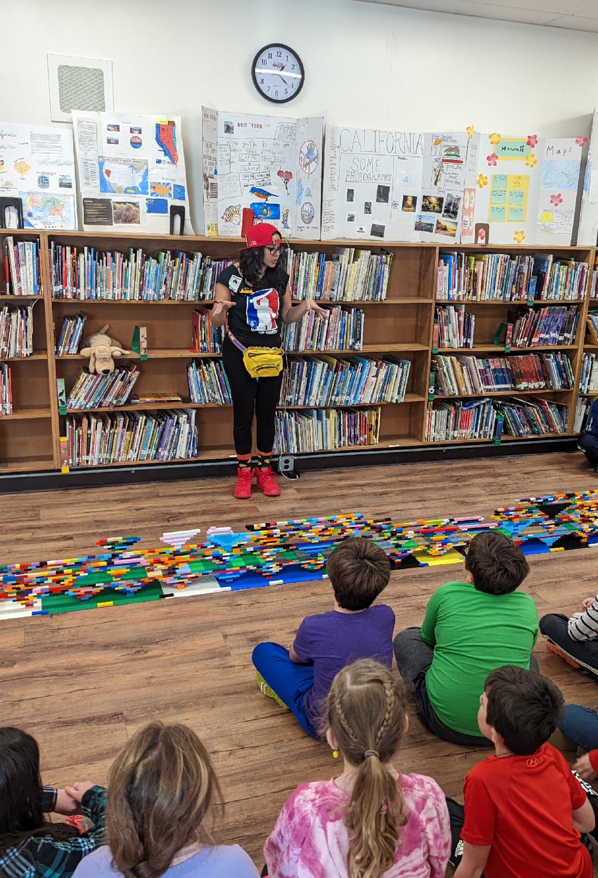 Christine "Tacos" Blandino teaches Portsmouth elementary students about compression, creativity, stability, and teamwork while building a massive Lego bridge