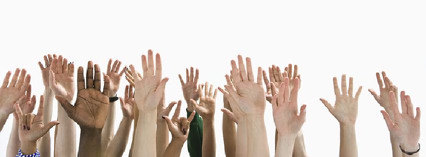 Photograph of many raised hands