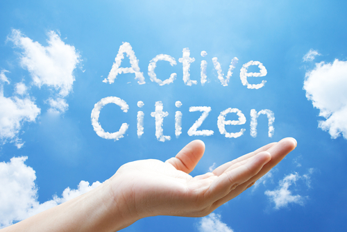 Active Citizen- A cloud word floating on upturned hands.