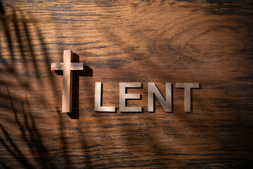 Cross and Lent word as fast and abstinence period concept. Top view