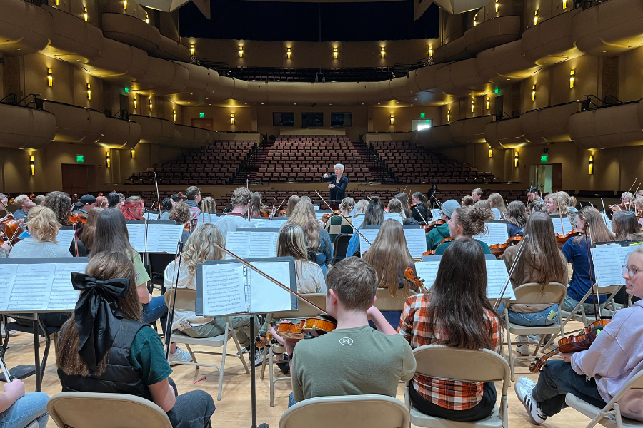 An auditorium filled with Orchestra students on stage