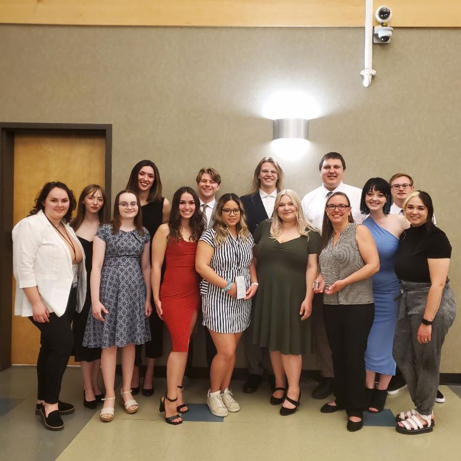 13 students from the National Student Advertising Competition and their faculty advisor pose for a photo