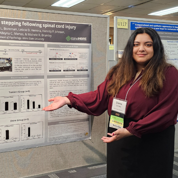 Diana Cortez stands in front of her poster presentation at the INBRE conference