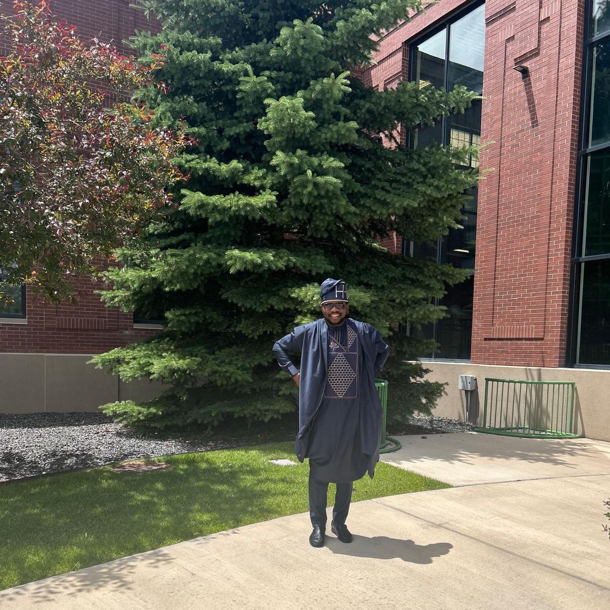 Photo of Taiwo standing outside in traditional dress