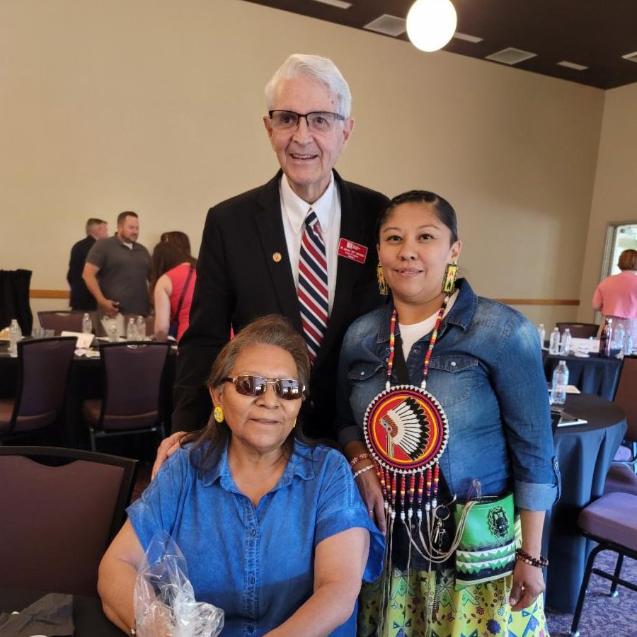 Drusilla Gould and two others smile for a photo at the Esto Perpetua Awards banquet table
