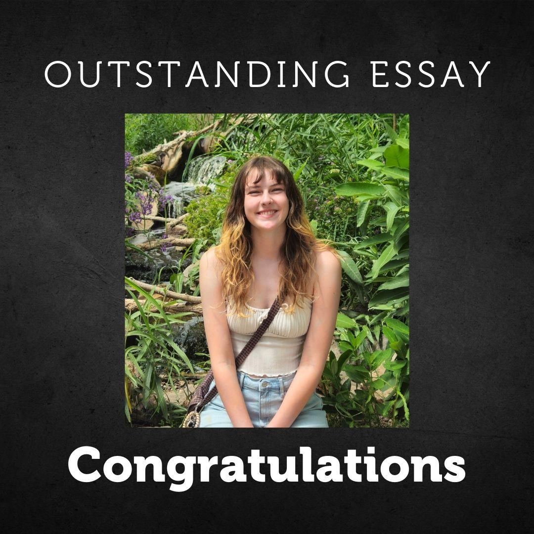 Photo of Chloe. She is sitting outside among green foliage. The text says "Congratulations"