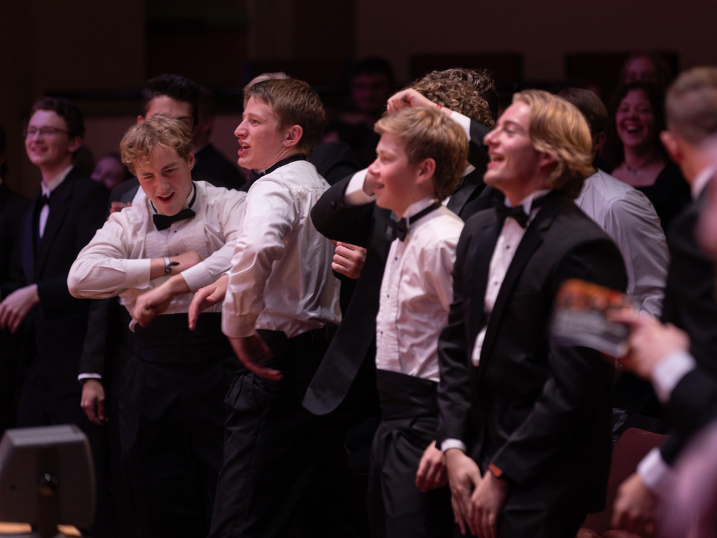 Lesa and Sharon stand behind a grocery cart full of food and toilet paper