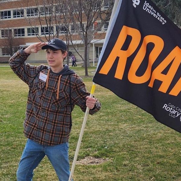 Hawkins holding a Roar flag