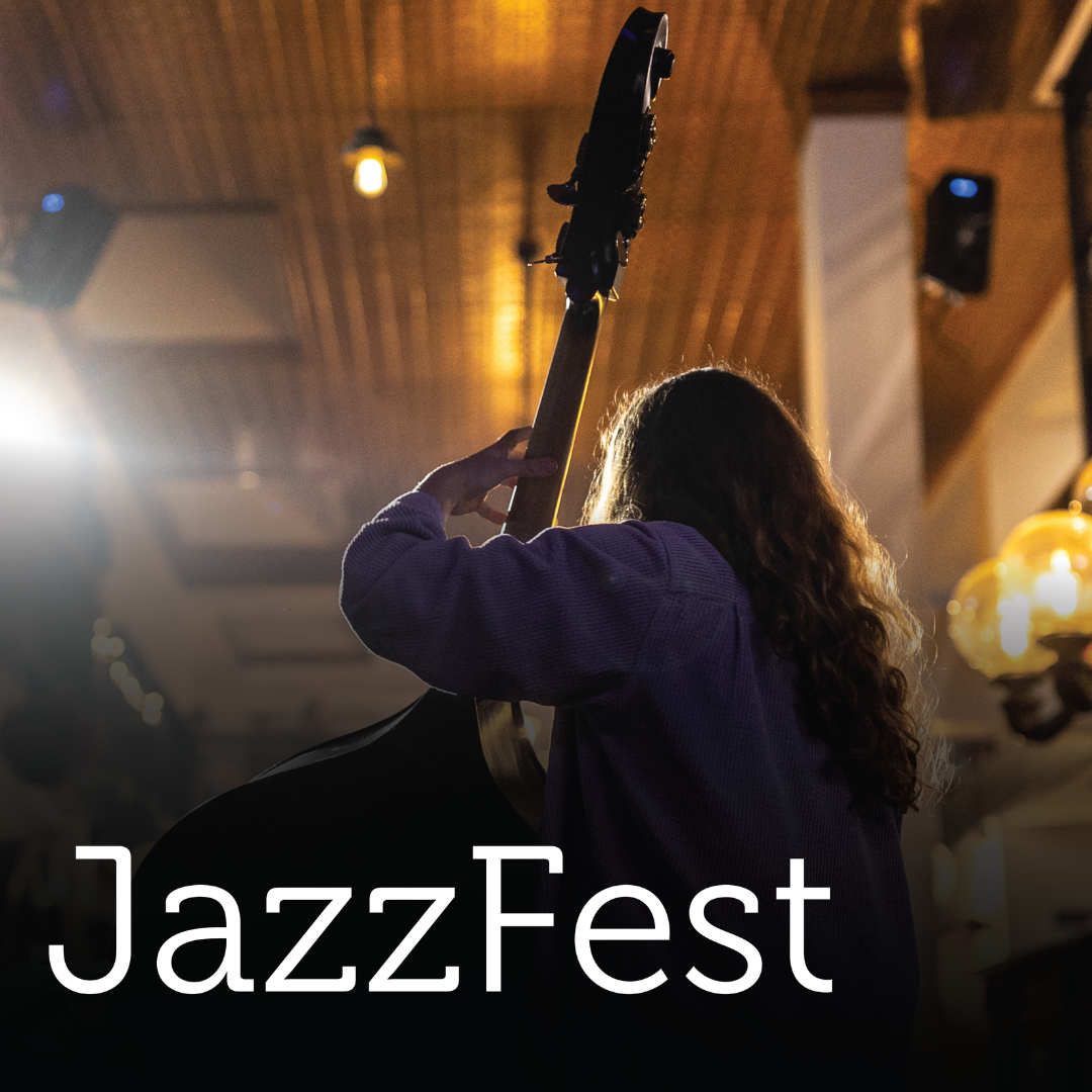 A person with long hair plays an upright bass at a JazzFest, with warm ambient lighting and "JazzFest" written in bold white text.  Transcribed Text:  JazzFest.