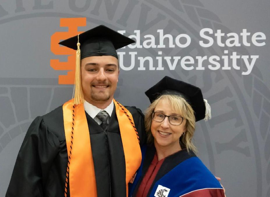 Dean Kandi Turley Ames and her son Evan pose together at graduation in their commencement regalia