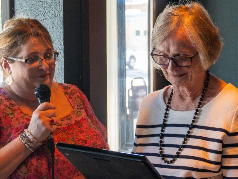 Dr. Ann Hunter is presented a plaque by her daughter, Suzanne Bentley
