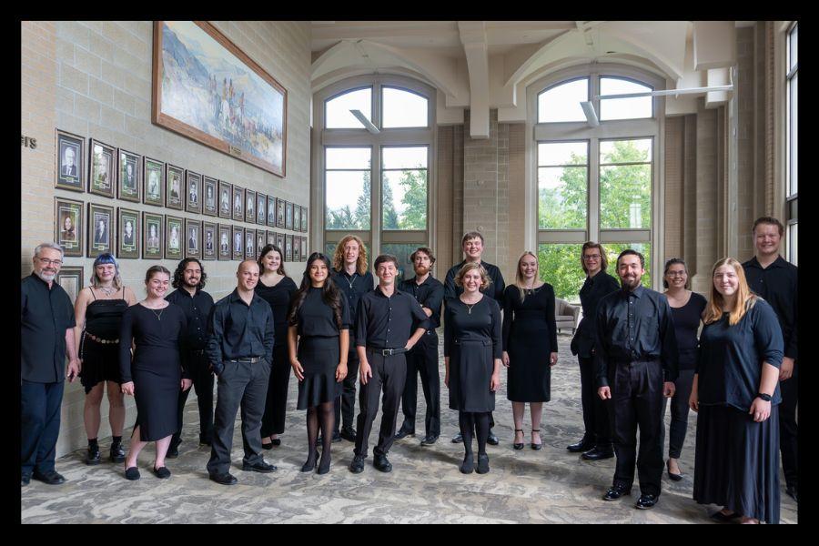 Chamber choir members pose in the Stephen's Performing Arts Center 