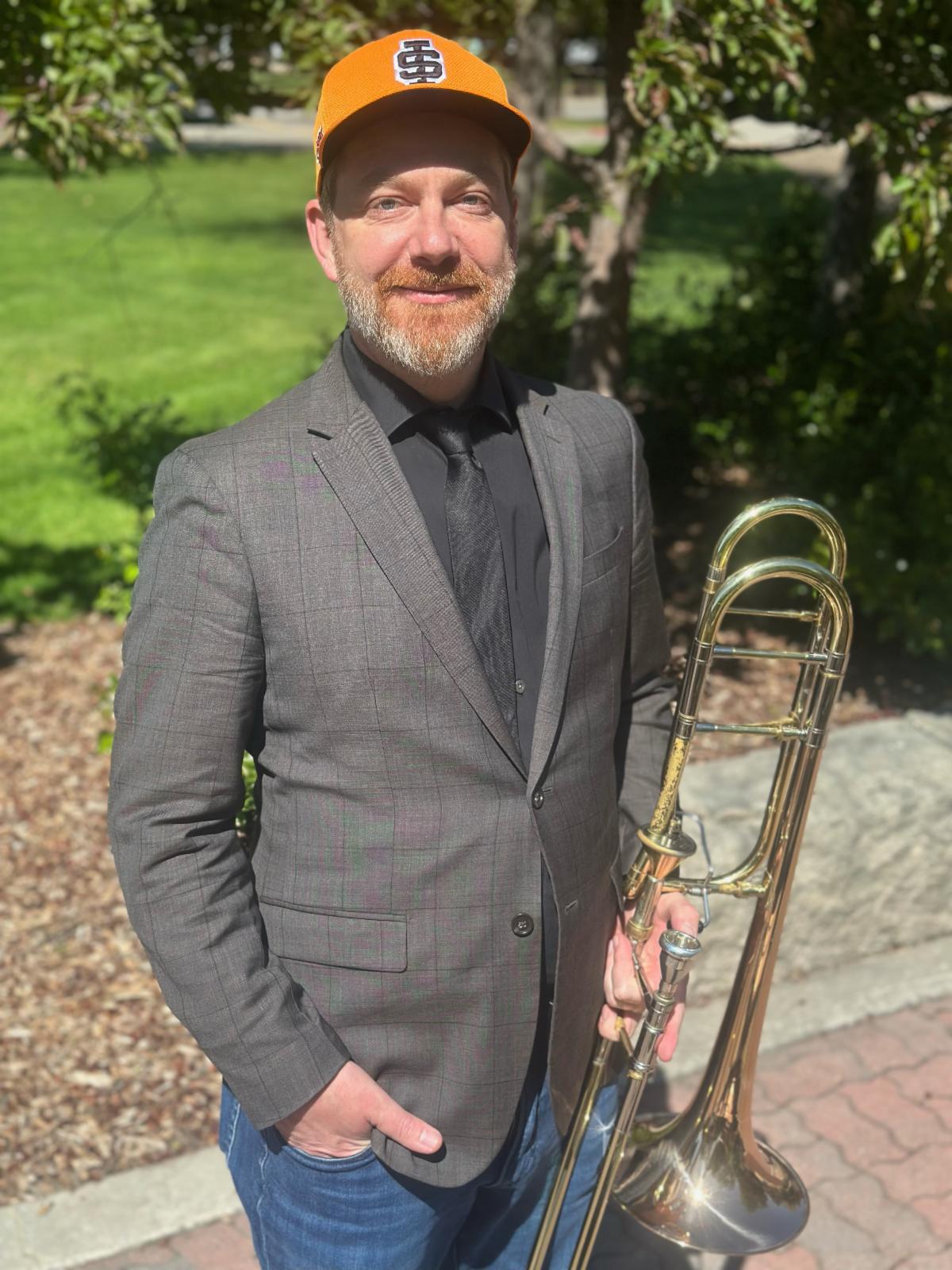 Luke Strother with ISU hat and trombone