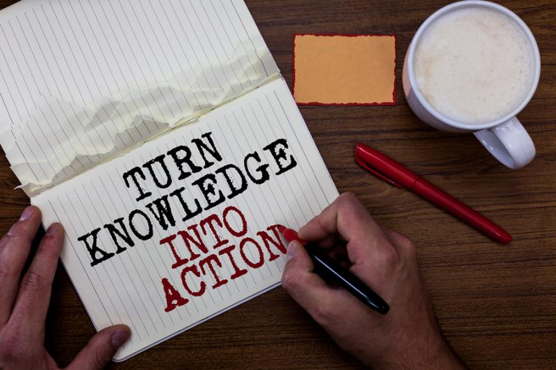 Handwriting text writing Turn Knowledge Into Action. Concept meaning Apply what you have learned Leadership strategies Sticky note red pen coffee with coffee mug hand hold pen with written words.