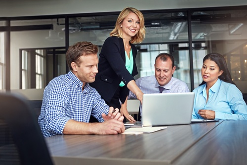 Business people_ meeting and review in office with laptop_ audit and financial report for discussion. Portrait_ team and point in workplace with computer_ conversation or finance info for accounting.