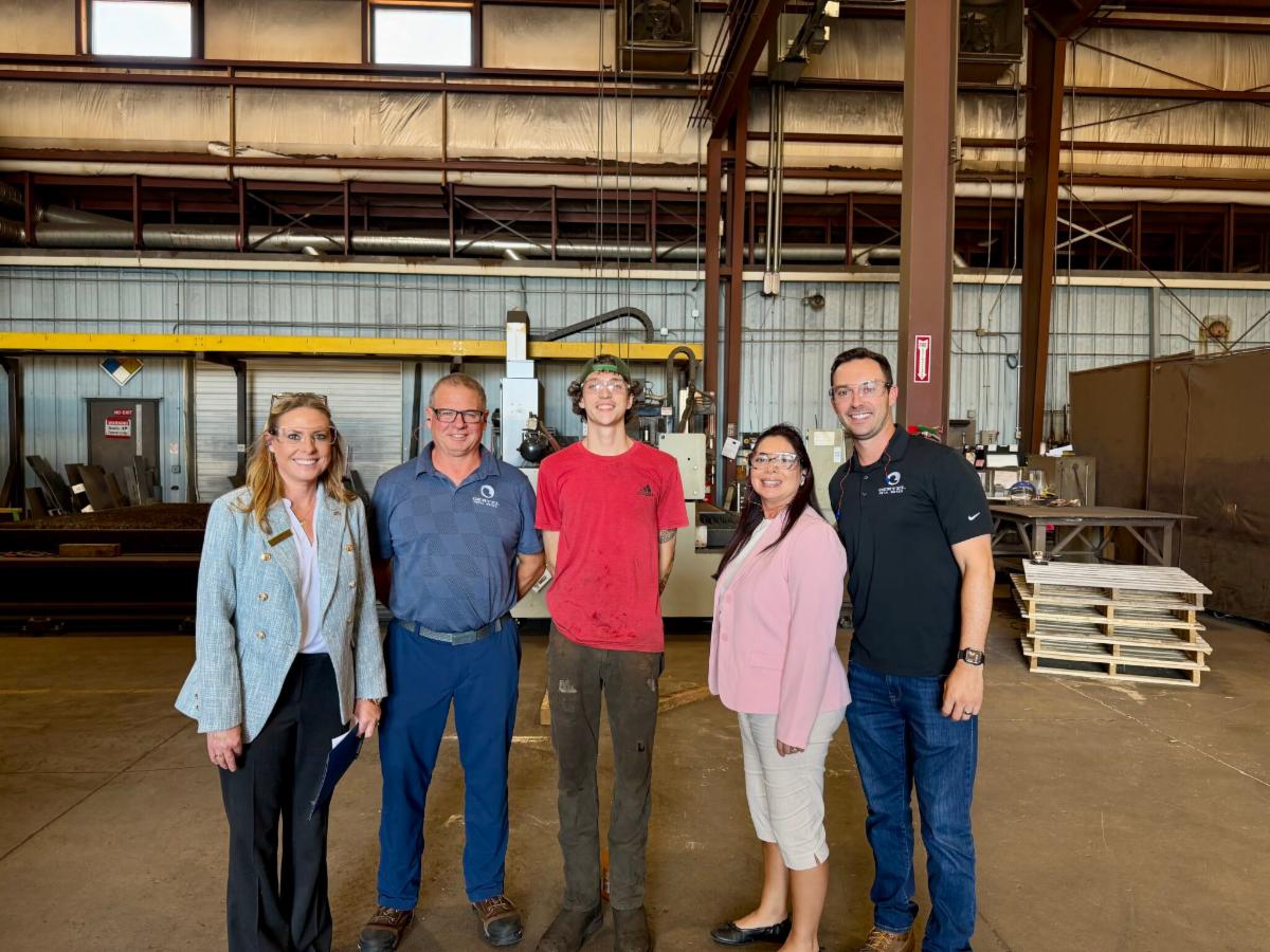 Brian Krzyaniak, EIWB Member and President of Oertel Metal Works, with DOL representatives and one of his apprentices.