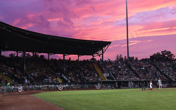 Pink sky sunset at Centennial Field during a Lake Monsters baseball game. 