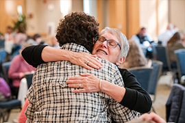 Two people hugging at the 2022 Women's Health and Cancer Conference