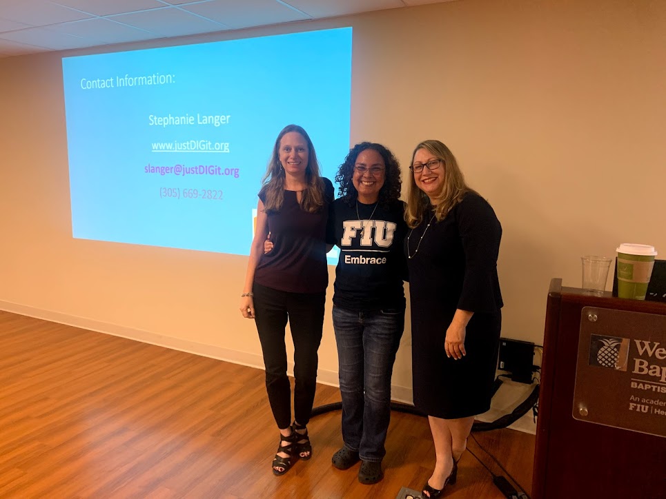 Debbie Nicole and Stephanie standing in front of a screen for a presentation about SSI benefits