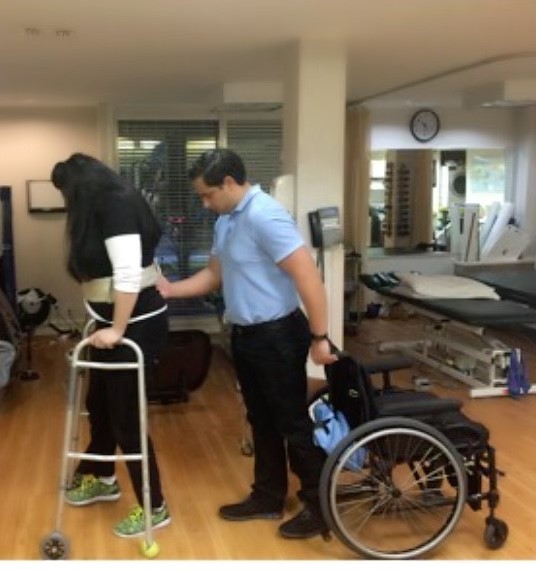 Photo of Justine with Walker and her Physical Therapist