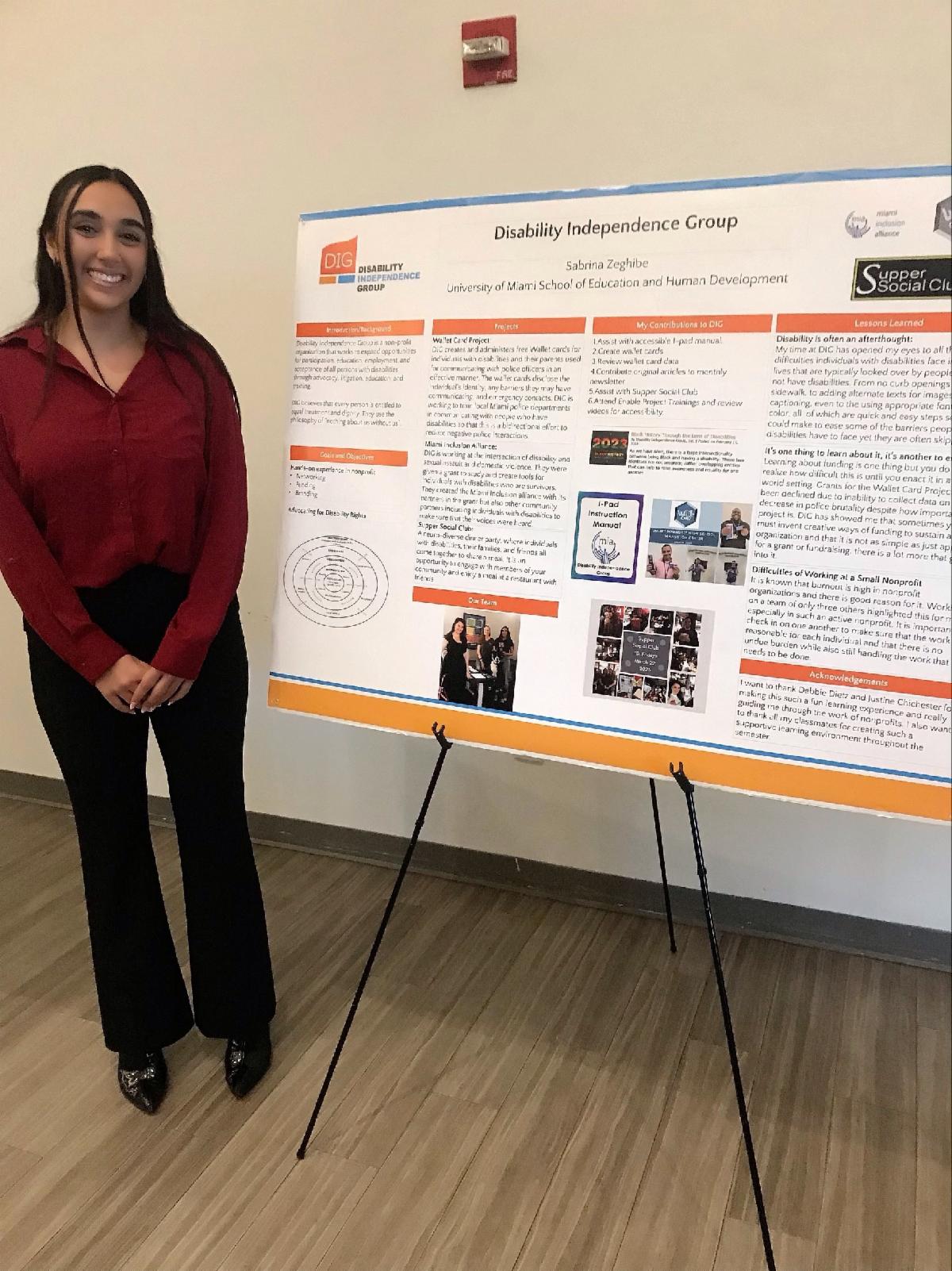 Sabrina in front of her DIG Summary Board