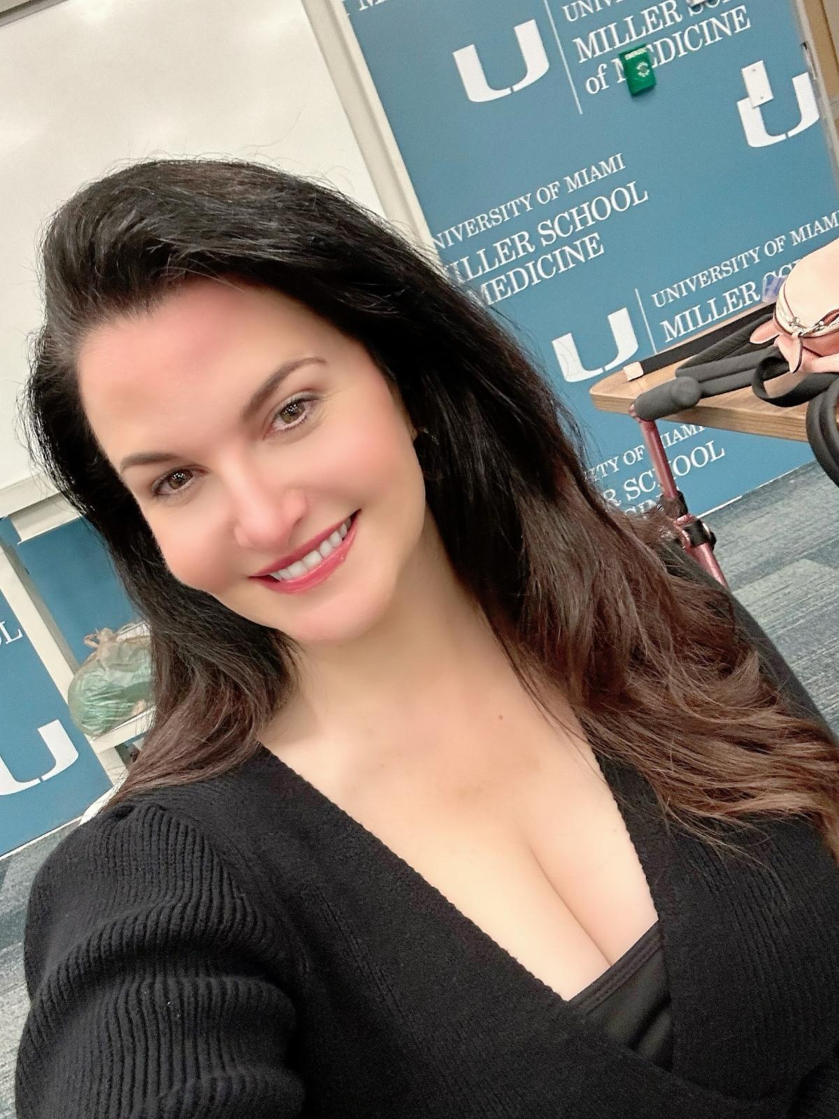 Photo of Justine in front of UM Medical School wall